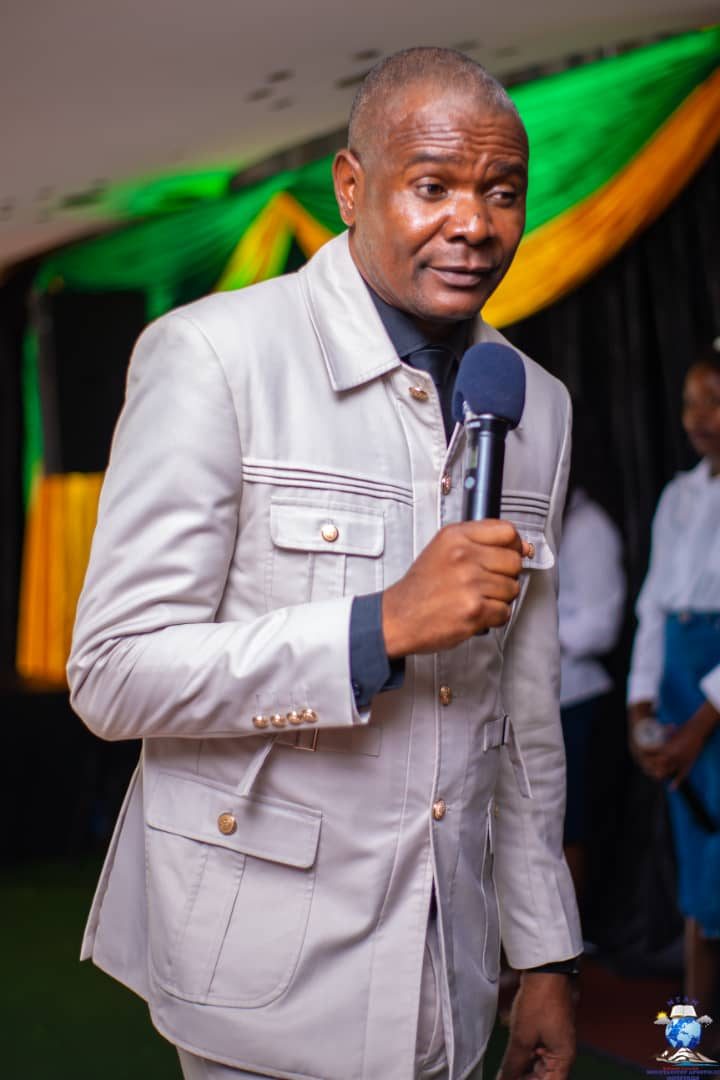 Apostle B. Jophress, founder and president, holding a microphone