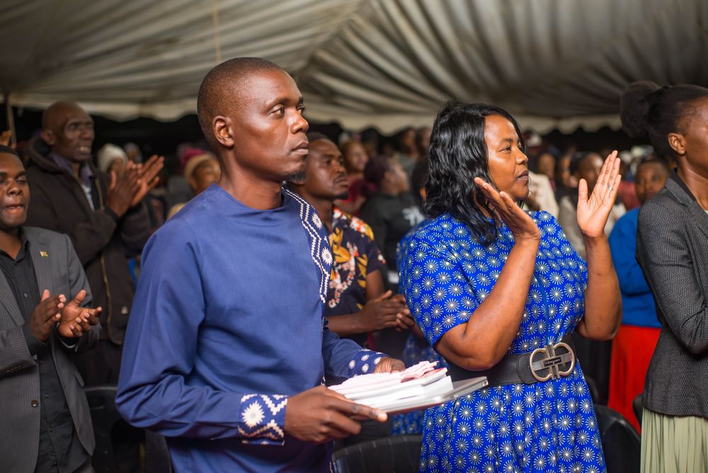 Bishop Saburi holding his Bible in the congregation