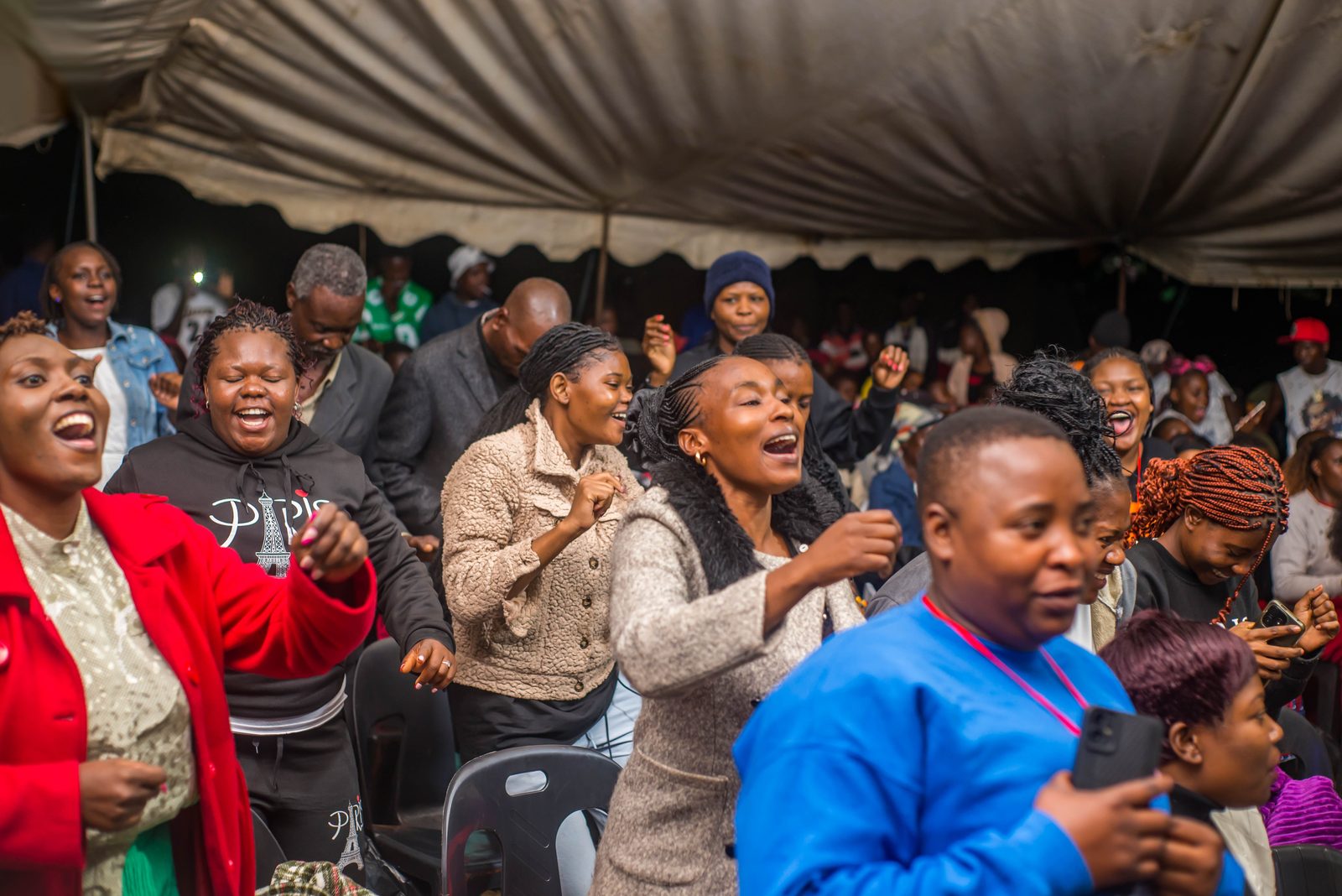 Youth dancing with joy at a night crusade