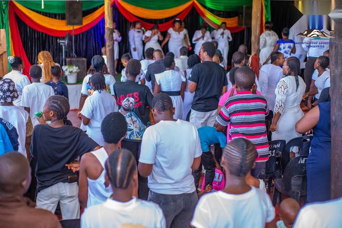 Members in white gathered at the Easter conference