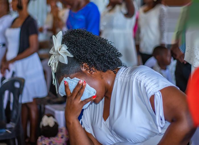 Hands lifted in worship inside the tent