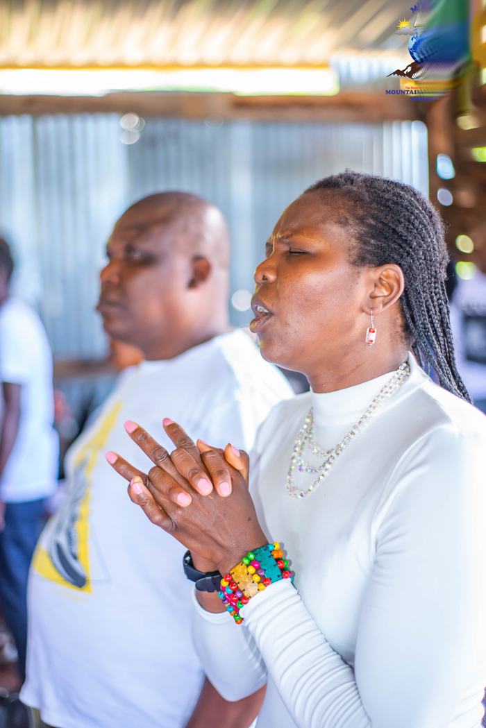 Members in white worshipping together